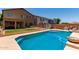 Backyard featuring a refreshing pool surrounded by grass and a patio at 11836 W Planada Ct, Sun City, AZ 85373