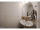 Powder room featuring decorative backsplash and pedestal sink with modern fixtures at 1350 S Greenfield Rd # 1130, Mesa, AZ 85206