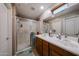Bright bathroom featuring double sinks, spacious shower, and ample lighting at 1350 S Greenfield Rd # 1130, Mesa, AZ 85206