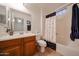 Bathroom featuring a single sink vanity, tile floors, and a shower with a decorative curtain at 1350 S Greenfield Rd # 1130, Mesa, AZ 85206