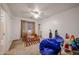 Bright bedroom features a ceiling fan and a window with wood-slat blinds at 1350 S Greenfield Rd # 1130, Mesa, AZ 85206
