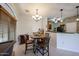 Open-concept dining area with tile floors, a round table, and an adjacent breakfast bar at 1350 S Greenfield Rd # 1130, Mesa, AZ 85206