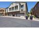 Two-story townhouse with three garages and stone accents, located at 2128 E Eagle Dr #65 at 1350 S Greenfield Rd # 1130, Mesa, AZ 85206