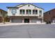 Two-story townhouse with three garages, stone accents, and desert landscaping at 1350 S Greenfield Rd # 1130, Mesa, AZ 85206