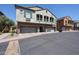 Two-story townhome featuring a stucco exterior, arched balconies, and three-car garages at 1350 S Greenfield Rd # 1130, Mesa, AZ 85206