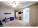 Spacious carpeted main bedroom featuring a ceiling fan, tv, and access to the main bathroom at 1350 S Greenfield Rd # 1130, Mesa, AZ 85206
