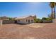 View of gravel backyard featuring block fence and desert landscaping at 15440 W Mauna Loa Ln, Surprise, AZ 85379