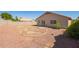 View of gravel backyard featuring block fence and desert landscaping at 15440 W Mauna Loa Ln, Surprise, AZ 85379