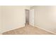 Neutral bedroom featuring neutral paint, neutral carpet, and interior door at 15440 W Mauna Loa Ln, Surprise, AZ 85379