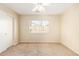 Bright bedroom featuring neutral walls, a ceiling fan, and a window letting in plenty of light at 15440 W Mauna Loa Ln, Surprise, AZ 85379