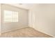 Bedroom with neutral walls, carpet, closet, and a window providing natural light at 15440 W Mauna Loa Ln, Surprise, AZ 85379