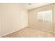 Cozy bedroom with neutral walls, carpet, closet, and a window providing natural light at 15440 W Mauna Loa Ln, Surprise, AZ 85379