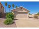 Inviting single-story home with a two-car garage and a well-manicured front yard at 15440 W Mauna Loa Ln, Surprise, AZ 85379