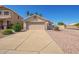 Charming single-story home with a two-car garage, desert landscaping, and sunny skies at 15440 W Mauna Loa Ln, Surprise, AZ 85379