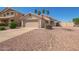 Welcoming single-story home with a two-car garage, desert landscaping, and a clear blue sky at 15440 W Mauna Loa Ln, Surprise, AZ 85379