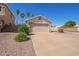 Lovely one-story home featuring a two-car garage, mature landscaping, and serene neighborhood views at 15440 W Mauna Loa Ln, Surprise, AZ 85379