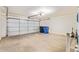 Spacious garage with a white door and ample storage space at 15440 W Mauna Loa Ln, Surprise, AZ 85379