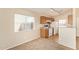 Compact kitchen featuring modern appliances, track lighting, and a cozy dining nook at 15440 W Mauna Loa Ln, Surprise, AZ 85379