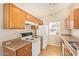 Functional kitchen featuring wooden cabinets, ample counter space, and standard appliances at 15440 W Mauna Loa Ln, Surprise, AZ 85379