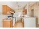 Functional kitchen featuring wooden cabinets, ample counter space, and standard appliances at 15440 W Mauna Loa Ln, Surprise, AZ 85379