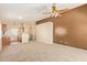 Inviting living area showcasing carpeted floors, ample space, and a connecting kitchen area at 15440 W Mauna Loa Ln, Surprise, AZ 85379