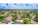 Aerial neighborhood view showcasing a home with a pool and a three car garage at 1571 E Saratoga Ct, Gilbert, AZ 85296