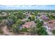 Expansive aerial view of a charming neighborhood featuring lush green landscaping and private backyard pools at 1571 E Saratoga Ct, Gilbert, AZ 85296