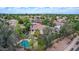 Aerial shot showcasing a home with a private pool, mature trees, and a well-manicured backyard at 1571 E Saratoga Ct, Gilbert, AZ 85296