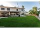 Beautiful backyard with green lawn, mature trees, and a spacious outdoor living area at 1571 E Saratoga Ct, Gilbert, AZ 85296
