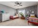 Charming bedroom with two red twin beds, a white dresser, and bright natural light at 1571 E Saratoga Ct, Gilbert, AZ 85296