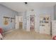 Neutral bedroom with walk in closet and view of hall, includes built in bookshelves and peg rack at 1571 E Saratoga Ct, Gilbert, AZ 85296