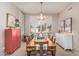 Elegant dining room featuring a long wooden table, stylish decor, and natural lighting at 1571 E Saratoga Ct, Gilbert, AZ 85296