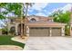Expansive two-story home boasting a three-car garage, tiled roof, and well-manicured landscaping at 1571 E Saratoga Ct, Gilbert, AZ 85296