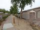 Side view of the horse barn and stall area, featuring rock support posts and desert landscaping with walkway at 1571 E Saratoga Ct, Gilbert, AZ 85296