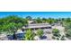 Aerial view of the horse barn showing stalls, desert landscaping, and surrounding tree coverage on a clear day at 1571 E Saratoga Ct, Gilbert, AZ 85296