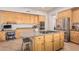 Modern kitchen with a center island cooktop, stainless steel appliances, and built-in desk area at 1571 E Saratoga Ct, Gilbert, AZ 85296