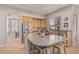 Stylish kitchen featuring an island with seating, stainless steel appliances, and casual dining area at 1571 E Saratoga Ct, Gilbert, AZ 85296