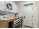 Laundry room featuring front load washer and dryer with white cabinets at 1571 E Saratoga Ct, Gilbert, AZ 85296