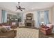Inviting living room showcasing a stone fireplace, cozy seating, and charming decor at 1571 E Saratoga Ct, Gilbert, AZ 85296