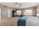 Bright main bedroom with neutral colors, a ceiling fan, and a view of the neighborhood at 1571 E Saratoga Ct, Gilbert, AZ 85296