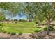 Picturesque community open space with walking path and a manicured lawn surrounded by mature trees at 1571 E Saratoga Ct, Gilbert, AZ 85296