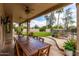 Covered patio with an outdoor dining area perfect for entertaining guests, plus a fan at 1571 E Saratoga Ct, Gilbert, AZ 85296
