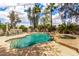 Gorgeous pool with waterfall feature, lush landscaping, and a spacious patio area for lounging and entertaining at 1571 E Saratoga Ct, Gilbert, AZ 85296