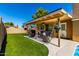 Outdoor living space with a covered patio, manicured turf, and beautiful hanging flower baskets, great for entertaining at 1630 W Calle Del Norte --, Chandler, AZ 85224