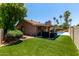 Expansive backyard with artificial turf, covered patio, and inviting swimming pool at 1630 W Calle Del Norte --, Chandler, AZ 85224
