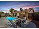 Relaxing backyard with a sparkling blue pool, covered patio, and comfortable seating, perfect for outdoor enjoyment at 1630 W Calle Del Norte --, Chandler, AZ 85224