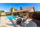 Outdoor living space featuring a sparkling pool, patio seating, and beautifully landscaped backyard at 1630 W Calle Del Norte --, Chandler, AZ 85224