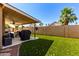 Backyard featuring a covered patio and verdant lawn, perfect for outdoor entertaining and relaxing at 1630 W Calle Del Norte --, Chandler, AZ 85224