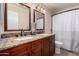 Bathroom vanity features double sinks, granite countertop, and dark wood cabinetry at 1630 W Calle Del Norte --, Chandler, AZ 85224