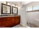 Bathroom featuring double sinks, wooden cabinets, granite countertops, and an enclosed shower at 1630 W Calle Del Norte --, Chandler, AZ 85224